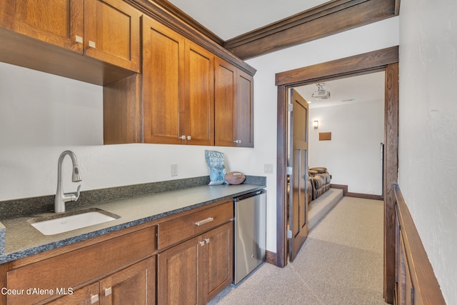 4618 S Scenic Dr, Coeur Dalene, ID 83814 - kitchen with fridge, a sink, brown cabinetry, light colored carpet, and dark stone countertops