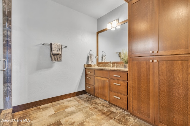 4618 S Scenic Dr, Coeur Dalene, ID 83814 - full bathroom with vanity, stone finish floors, and baseboards