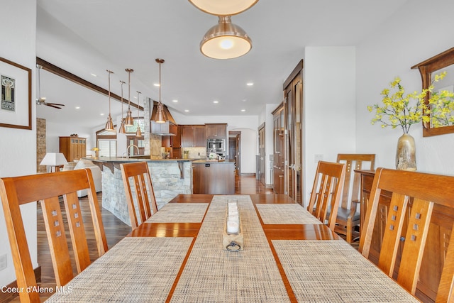 4618 S Scenic Dr, Coeur Dalene, ID 83814 - dining room featuring wood finished floors, ceiling fan, arched walkways, and recessed lighting