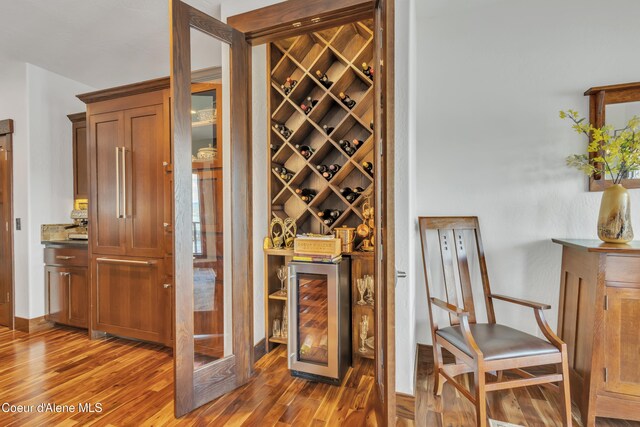 4618 S Scenic Dr, Coeur Dalene, ID 83814 - wine room with wine cooler, wood finished floors, and baseboards