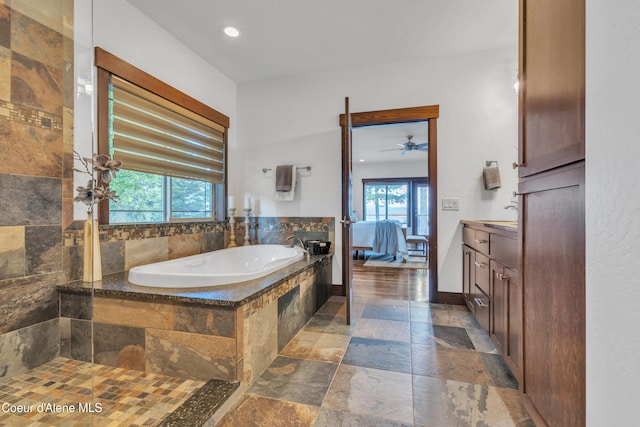 4618 S Scenic Dr, Coeur Dalene, ID 83814 - full bath with a bath, stone tile floors, vanity, connected bathroom, and a ceiling fan