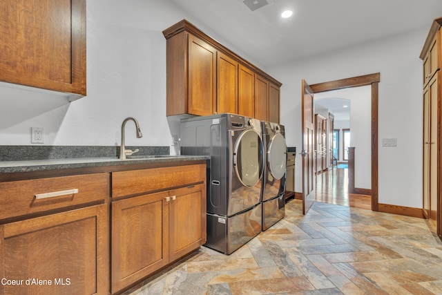 4618 S Scenic Dr, Coeur Dalene, ID 83814 - washroom featuring washing machine and clothes dryer, baseboards, cabinet space, and light stone finish floors