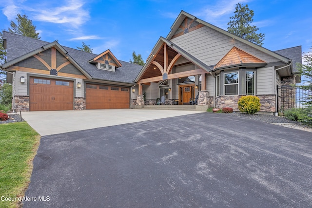 4618 S Scenic Dr, Coeur Dalene, ID 83814 - craftsman-style house featuring stone siding, asphalt driveway, a garage, and a porch