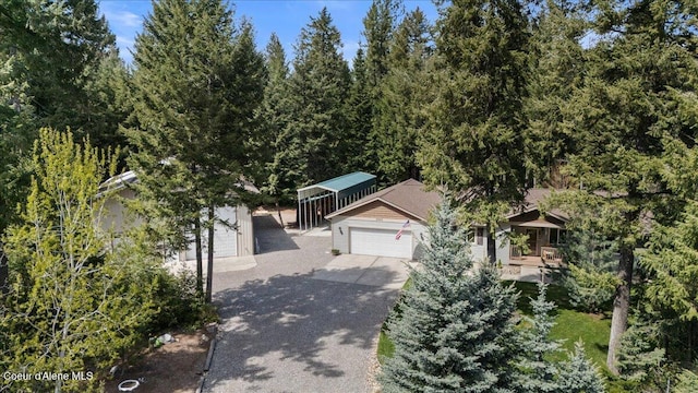 23815 N Rapalla Ct, Athol, ID 83801 - obstructed view of property featuring an attached garage and asphalt driveway