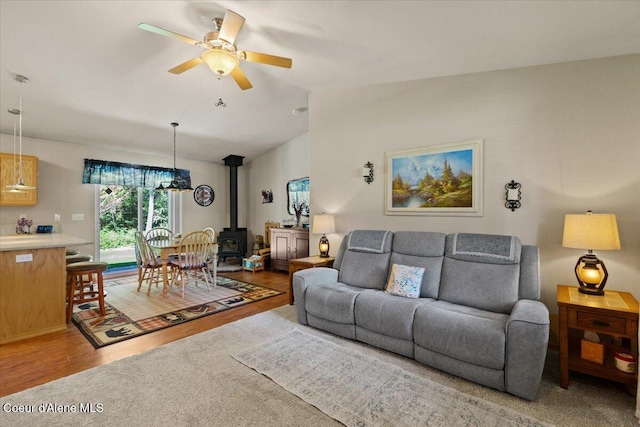 23815 N Rapalla Ct, Athol, ID 83801 - living area with a wood stove, ceiling fan, wood finished floors, and vaulted ceiling