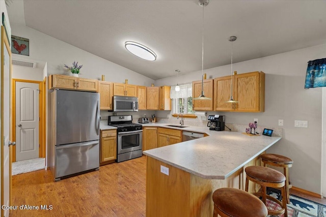 23815 N Rapalla Ct, Athol, ID 83801 - kitchen featuring stainless steel appliances, a sink, a peninsula, vaulted ceiling, and light countertops