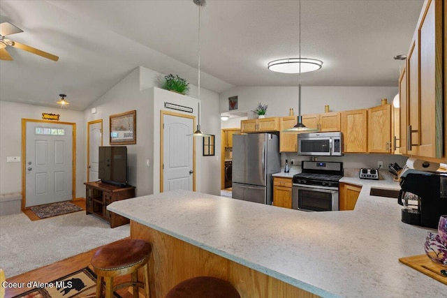 23815 N Rapalla Ct, Athol, ID 83801 - kitchen featuring appliances with stainless steel finishes, vaulted ceiling, a peninsula, light countertops, and ceiling fan