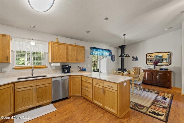 23815 N Rapalla Ct, Athol, ID 83801 - kitchen featuring stainless steel dishwasher, a sink, light countertops, and a peninsula