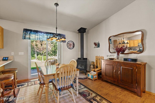 23815 N Rapalla Ct, Athol, ID 83801 - dining area with a chandelier, light wood-type flooring, and a wood stove