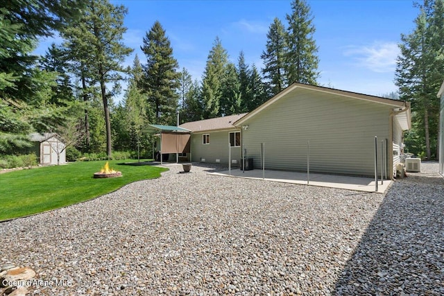 23815 N Rapalla Ct, Athol, ID 83801 - rear view of property featuring a fire pit, a patio area, and a yard