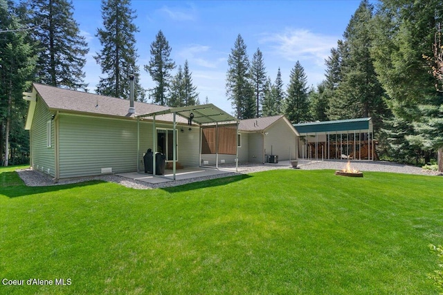 23815 N Rapalla Ct, Athol, ID 83801 - rear view of house featuring an outdoor fire pit, a patio area, a yard, and central AC