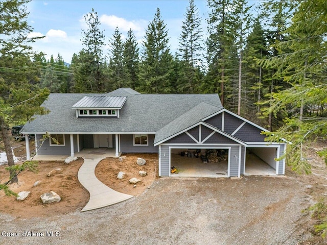10233 Bunco Rd, Athol, ID 83801 - view of front facade with a porch, driveway, a garage, and roof with shingles
