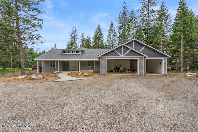 10233 Bunco Rd, Athol, ID 83801 - view of front facade with dirt driveway, roof with shingles, and an attached garage