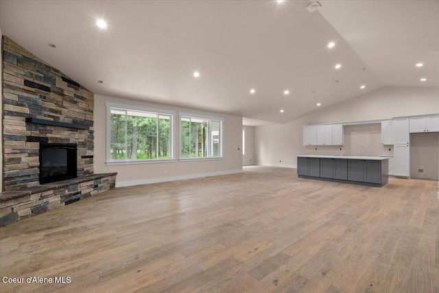 10233 Bunco Rd, Athol, ID 83801 - unfurnished living room with a fireplace, light wood-style flooring, recessed lighting, baseboards, and high vaulted ceiling