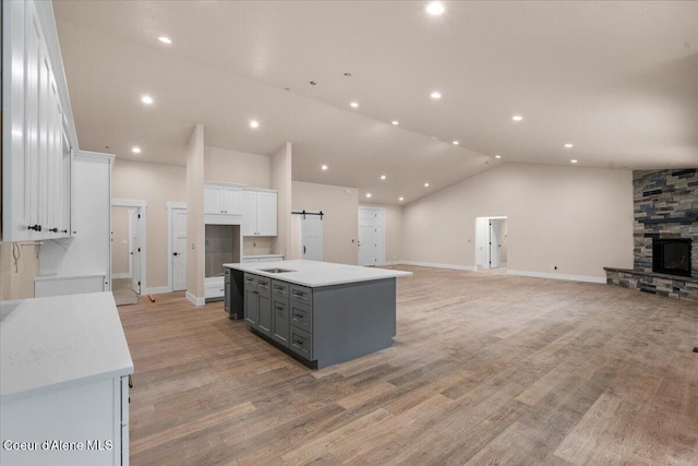 10233 Bunco Rd, Athol, ID 83801 - kitchen featuring gray cabinets, white cabinets, vaulted ceiling, open floor plan, and a kitchen island