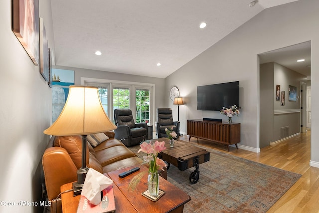 5030 E Frazier Dr, Post Falls, ID 83854 - living room featuring lofted ceiling, light wood-style flooring, recessed lighting, and baseboards