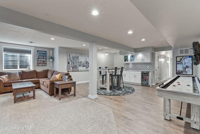 5030 E Frazier Dr, Post Falls, ID 83854 - living room with beverage cooler, wet bar, light wood-style flooring, baseboards, and recessed lighting