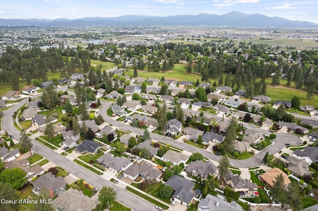 5030 E Frazier Dr, Post Falls, ID 83854 - aerial overview of property's location with a mountainous background and nearby suburban area