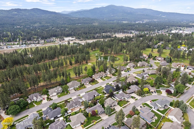 5030 E Frazier Dr, Post Falls, ID 83854 - aerial view of property and surrounding area featuring mountains, nearby suburban area, and a forest