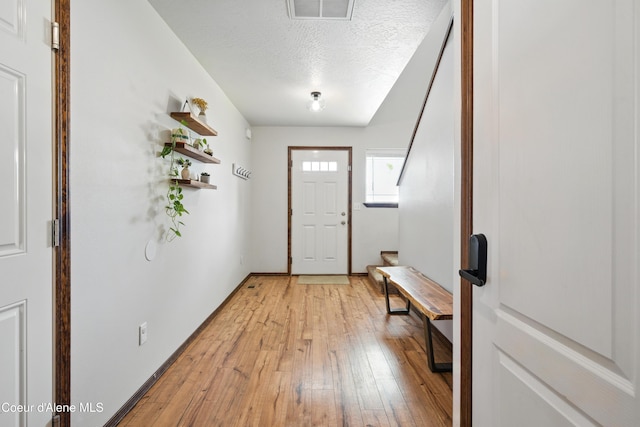 12404 W Devonshire Ave, Post Falls, ID 83854 - entryway featuring light wood-style flooring and a textured ceiling