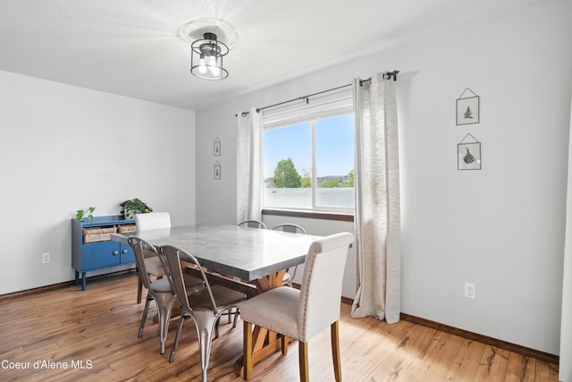 12404 W Devonshire Ave, Post Falls, ID 83854 - dining area featuring light wood-style flooring and baseboards