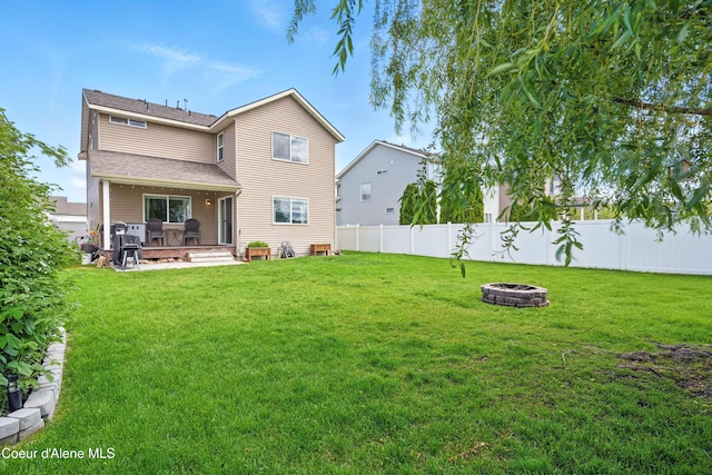 12404 W Devonshire Ave, Post Falls, ID 83854 - rear view of house with an outdoor fire pit, a deck, and roof with shingles