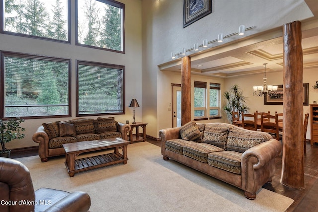 225 Fairway Dr, Priest Lake, ID 83856 - living area featuring a chandelier, baseboards, and decorative columns
