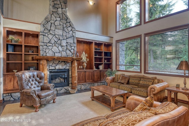 225 Fairway Dr, Priest Lake, ID 83856 - living room featuring plenty of natural light, a fireplace, a high ceiling, and built in shelves
