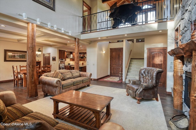 225 Fairway Dr, Priest Lake, ID 83856 - living area with stairs, wood finished floors, decorative columns, a high ceiling, and baseboards