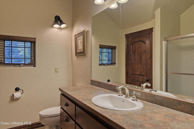 225 Fairway Dr, Priest Lake, ID 83856 - bathroom featuring a textured wall, vanity, toilet, and a shower stall