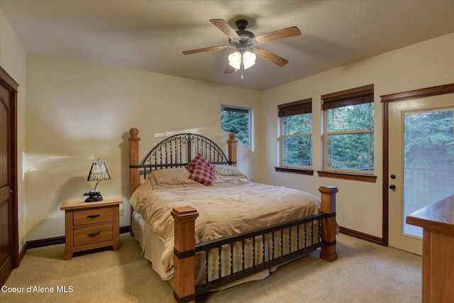 225 Fairway Dr, Priest Lake, ID 83856 - bedroom with light carpet, access to outside, multiple windows, and baseboards