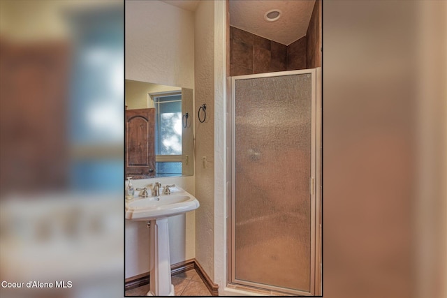 225 Fairway Dr, Priest Lake, ID 83856 - full bath with a shower stall, tile patterned flooring, and a sink