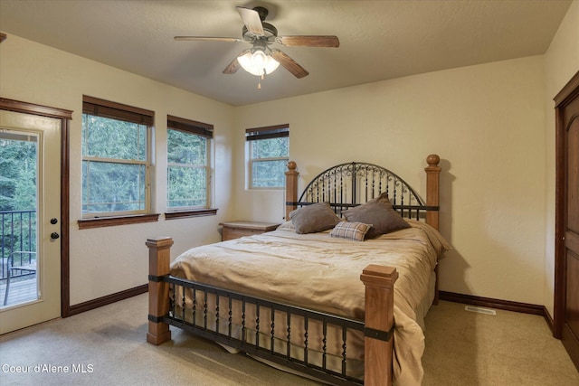 225 Fairway Dr, Priest Lake, ID 83856 - bedroom featuring access to exterior, light colored carpet, and baseboards