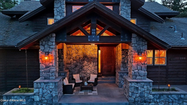 225 Fairway Dr, Priest Lake, ID 83856 - doorway to property featuring a shingled roof and stone siding