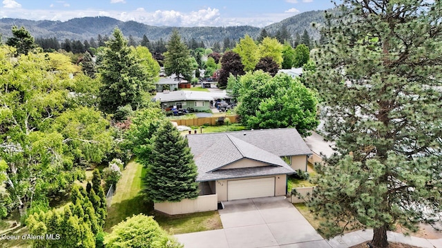 3012 N 4th St, Coeur Dalene, ID 83815 - aerial view of property and surrounding area with a mountainous background and a forest