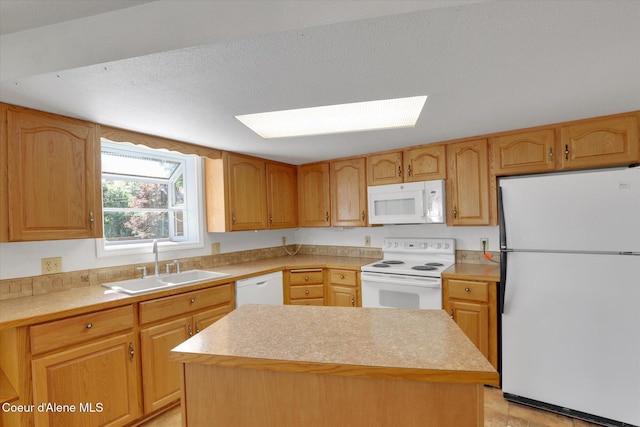 3012 N 4th St, Coeur Dalene, ID 83815 - kitchen featuring white appliances, a sink, a skylight, light countertops, and a center island