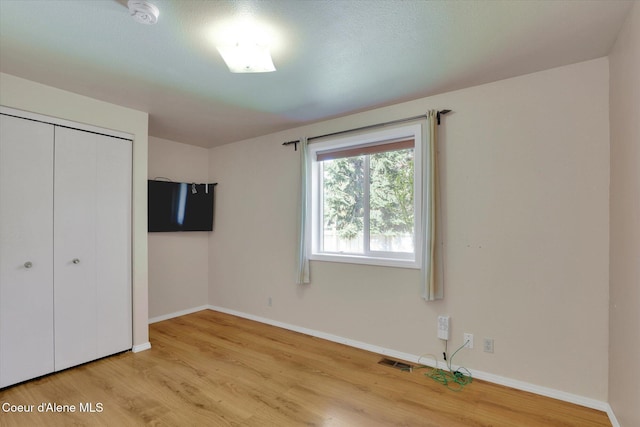 3012 N 4th St, Coeur Dalene, ID 83815 - unfurnished bedroom with light wood-type flooring, baseboards, and a closet