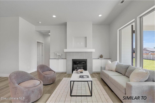 1109 N Country Club Dr Unit 22, Deer Park, WA 99006 - living room with light wood-style floors, a tile fireplace, recessed lighting, and baseboards