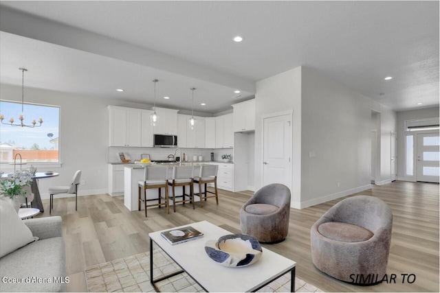 1109 N Country Club Dr Unit 22, Deer Park, WA 99006 - living room with light wood finished floors, a chandelier, recessed lighting, and baseboards