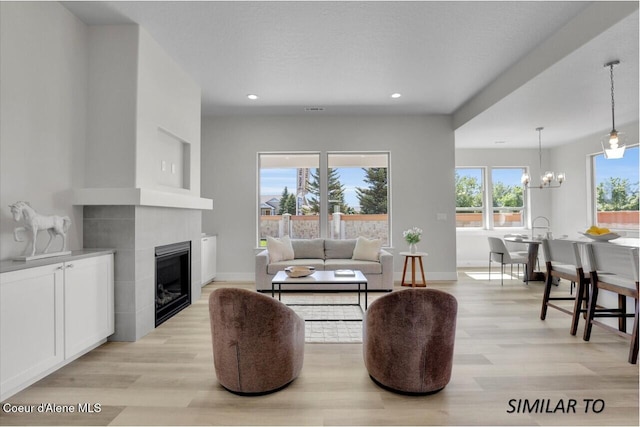1109 N Country Club Dr Unit 22, Deer Park, WA 99006 - living room with light wood-style flooring, a chandelier, a fireplace, baseboards, and recessed lighting