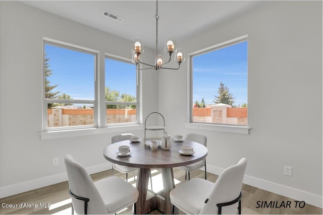 1109 N Country Club Dr Unit 22, Deer Park, WA 99006 - dining area featuring a chandelier, baseboards, and wood finished floors