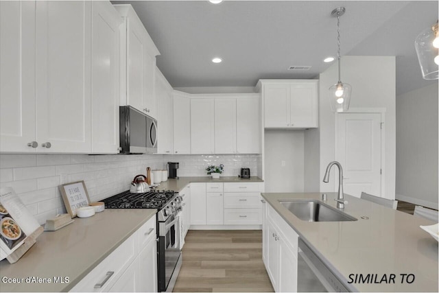 1109 N Country Club Dr Unit 22, Deer Park, WA 99006 - kitchen with a sink, appliances with stainless steel finishes, white cabinetry, and recessed lighting