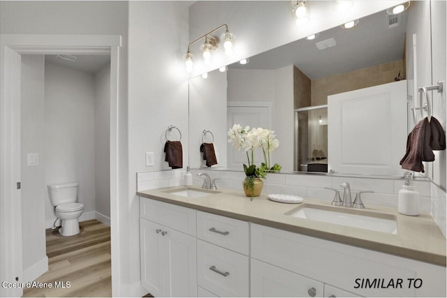 1109 N Country Club Dr Unit 22, Deer Park, WA 99006 - full bath with double vanity, a shower stall, toilet, wood finished floors, and baseboards