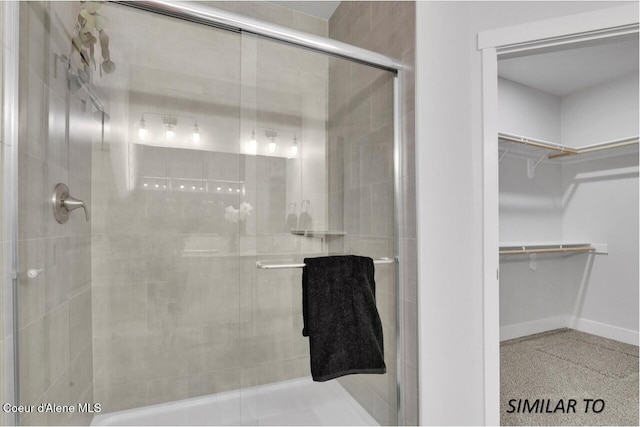 1109 N Country Club Dr Unit 22, Deer Park, WA 99006 - bathroom featuring a stall shower, baseboards, and a spacious closet