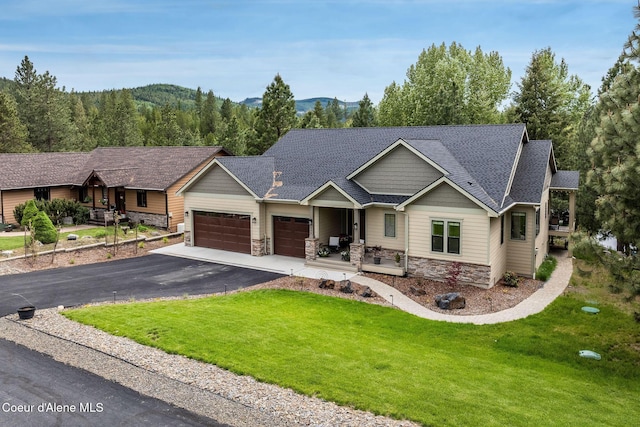 396 Hanaford Rd, Blanchard, ID 83804 - view of front of house featuring stone siding, a garage, and a front lawn