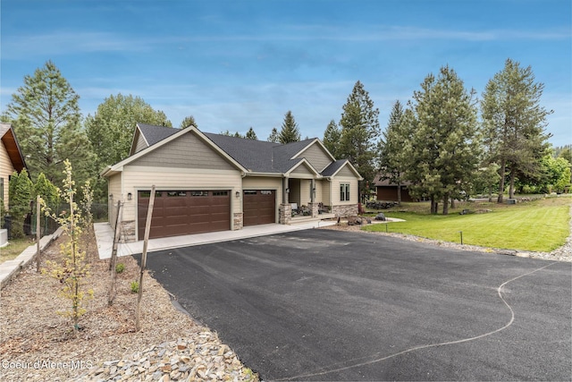 396 Hanaford Rd, Blanchard, ID 83804 - view of front of property featuring an attached garage, stone siding, asphalt driveway, and a front lawn