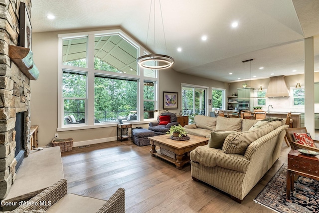 396 Hanaford Rd, Blanchard, ID 83804 - living area with a fireplace, vaulted ceiling, wood-type flooring, recessed lighting, and baseboards