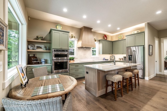 396 Hanaford Rd, Blanchard, ID 83804 - kitchen featuring stainless steel appliances, custom exhaust hood, a sink, green cabinets, and recessed lighting