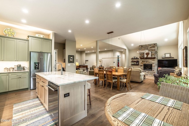 396 Hanaford Rd, Blanchard, ID 83804 - kitchen featuring a sink, appliances with stainless steel finishes, green cabinets, a fireplace, and wood finished floors