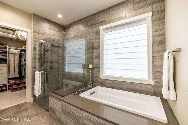 396 Hanaford Rd, Blanchard, ID 83804 - bathroom with a bath, a spacious closet, a shower stall, and recessed lighting
